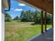 The home's backyard features ample greenspace viewed from a wood-trimmed covered porch with pillars at 1062 Sage Pine Cir, Clover, SC 29710