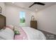Bright bedroom with window, plush bedding, ceiling fan, and a classic wooden dresser at 1062 Sage Pine Cir, Clover, SC 29710