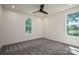The bedroom is filled with light from the two windows, and has neutral carpet at 1062 Sage Pine Cir, Clover, SC 29710