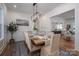 Elegant dining room with a modern chandelier, wainscoting, and an open view to the kitchen and living space at 1062 Sage Pine Cir, Clover, SC 29710