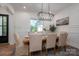 Bright dining room featuring a modern chandelier, wainscoting detail, and a large window at 1062 Sage Pine Cir, Clover, SC 29710