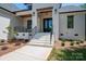Inviting front porch with decorative wood beam, brick facade, and black railings at 1062 Sage Pine Cir, Clover, SC 29710