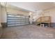 Spacious garage with a large overhead door and access stairs to an upper level at 1062 Sage Pine Cir, Clover, SC 29710