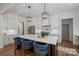 Open kitchen with a large island, white cabinets, and pendant lighting, perfect for gathering and cooking at 1062 Sage Pine Cir, Clover, SC 29710