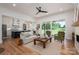 Open-concept living room with a fireplace, hardwood floors, and sliding glass doors at 1062 Sage Pine Cir, Clover, SC 29710