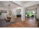 Bright open-concept living space with dining, kitchen, and seating area featuring hardwood floors and large windows at 1062 Sage Pine Cir, Clover, SC 29710