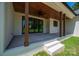 Spacious covered porch features stained wood ceiling, dark framed windows, and classic white pillars at 1062 Sage Pine Cir, Clover, SC 29710