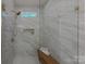 Modern shower featuring marble tile, glass enclosure, built-in niche, and a wooden bench at 1062 Sage Pine Cir, Clover, SC 29710