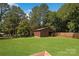 Large backyard with a storage shed on well-maintained green grass under a blue sky at 111 Berry St, Chester, SC 29706