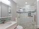 Elegant bathroom with a tiled glass shower and a stylish vanity with storage at 111 Berry St, Chester, SC 29706