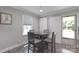 Bright dining room featuring neutral walls, hardwood floors, a large door, and bright natural light at 111 Berry St, Chester, SC 29706