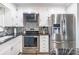 Bright kitchen with stainless steel appliances, white cabinetry, and stunning granite countertops at 111 Berry St, Chester, SC 29706