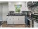 Modern kitchen features white cabinets, mosaic backsplash, and stainless steel appliances at 111 Berry St, Chester, SC 29706
