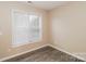 This bedroom features wood-look laminate flooring and natural light at 11305 Erwin Ridge Ave, Charlotte, NC 28213