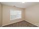 Bedroom with a neutral carpet and a window at 11305 Erwin Ridge Ave, Charlotte, NC 28213