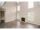 Bright living room featuring a fireplace, hardwood floors, and abundant natural light from large windows at 11305 Erwin Ridge Ave, Charlotte, NC 28213