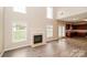 Bright living room featuring a fireplace, hardwood floors, and abundant natural light from large windows at 11305 Erwin Ridge Ave, Charlotte, NC 28213