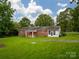 Home exterior highlighting backyard with patio, well-maintained lawn, and mature trees at 1132 Arbor Dr, Salisbury, NC 28144