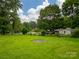 Expansive backyard showcasing a lush lawn, mature trees, and space for outdoor enjoyment at 1132 Arbor Dr, Salisbury, NC 28144
