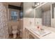 Bathroom features a white sink, patterned shower curtain, toilet, and a window for natural light at 1132 Arbor Dr, Salisbury, NC 28144