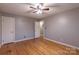 Cozy bedroom features hardwood floors, a ceiling fan, and ample space for relaxation at 1132 Arbor Dr, Salisbury, NC 28144