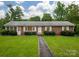 Charming brick home featuring a well-manicured lawn and walkway leading to the front door, perfect for curb appeal at 1132 Arbor Dr, Salisbury, NC 28144