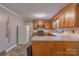 Efficient kitchen with wood cabinets and linoleum flooring, offering a functional and practical cooking space at 1132 Arbor Dr, Salisbury, NC 28144