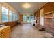 Bright sunroom with brick walls, large windows offering ample natural light, plus access to laundry area at 1132 Arbor Dr, Salisbury, NC 28144