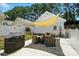 Backyard patio featuring a grill, outdoor seating, and a shaded awning at 11359 Deer Ridge Ln, Charlotte, NC 28277