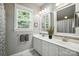 Bright bathroom featuring a double vanity, modern sinks, and updated lighting at 11359 Deer Ridge Ln, Charlotte, NC 28277