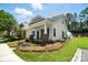 Charming home with a welcoming front porch, well-manicured lawn, and lovely landscaping at 11359 Deer Ridge Ln, Charlotte, NC 28277