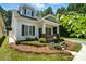 Charming home featuring a cozy front porch, well-maintained landscaping, and classic architectural details at 11359 Deer Ridge Ln, Charlotte, NC 28277