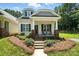 Charming home featuring a cozy front porch, well-maintained landscaping, and classic architectural details at 11359 Deer Ridge Ln, Charlotte, NC 28277
