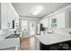 Modern kitchen featuring white cabinets, stainless steel appliances, and sleek countertops at 11359 Deer Ridge Ln, Charlotte, NC 28277