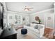Bright living room with neutral tones, stylish furnishings, ceiling fan, and natural light at 11359 Deer Ridge Ln, Charlotte, NC 28277