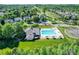 Aerial view of community pool and clubhouse surrounded by lush green trees and neighborhood homes at 115 Morrocroft Ln, Mooresville, NC 28117