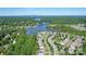 An aerial view of a lakeside community with houses nestled between lush green trees at 115 Morrocroft Ln, Mooresville, NC 28117