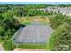 An aerial view of community tennis courts surrounded by lush green trees and neighborhood homes at 115 Morrocroft Ln, Mooresville, NC 28117