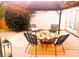 Back patio featuring four chairs and string lights in a grassy fenced yard at 115 Morrocroft Ln, Mooresville, NC 28117