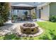 Inviting backyard featuring a stone fire pit and a cozy covered patio with outdoor seating and string lights at 115 Morrocroft Ln, Mooresville, NC 28117