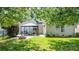 Large backyard with a gazebo, a fire pit, and lush green grass for outdoor enjoyment at 115 Morrocroft Ln, Mooresville, NC 28117
