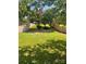 Well-maintained backyard featuring a lush green lawn surrounded by a wooden fence and mature trees at 115 Morrocroft Ln, Mooresville, NC 28117