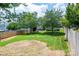 Expansive backyard featuring lush lawn, mature trees, privacy fence, and a cozy patio area at 115 Morrocroft Ln, Mooresville, NC 28117