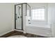 Bright bathroom with a tub and a separate glass enclosed shower at 115 Morrocroft Ln, Mooresville, NC 28117