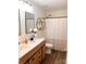 Bright bathroom featuring a double sink vanity, modern fixtures, and stylish wood-look flooring at 115 Morrocroft Ln, Mooresville, NC 28117