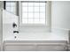 Close-up of a new bathtub with a white tile surround at 115 Morrocroft Ln, Mooresville, NC 28117