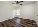 Cozy bedroom features hardwood floors, a ceiling fan, and natural light from a window at 115 Morrocroft Ln, Mooresville, NC 28117
