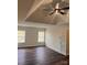 Spacious bedroom with wood flooring, modern ceiling fan, and ample natural light from the bright windows at 115 Morrocroft Ln, Mooresville, NC 28117