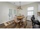 Cozy dining area featuring a round wooden table, comfortable chairs, and natural light at 115 Morrocroft Ln, Mooresville, NC 28117