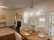 Elegant dining room with a wooden table, upholstered chairs, and a view of the cozy living room with a fireplace at 115 Morrocroft Ln, Mooresville, NC 28117
